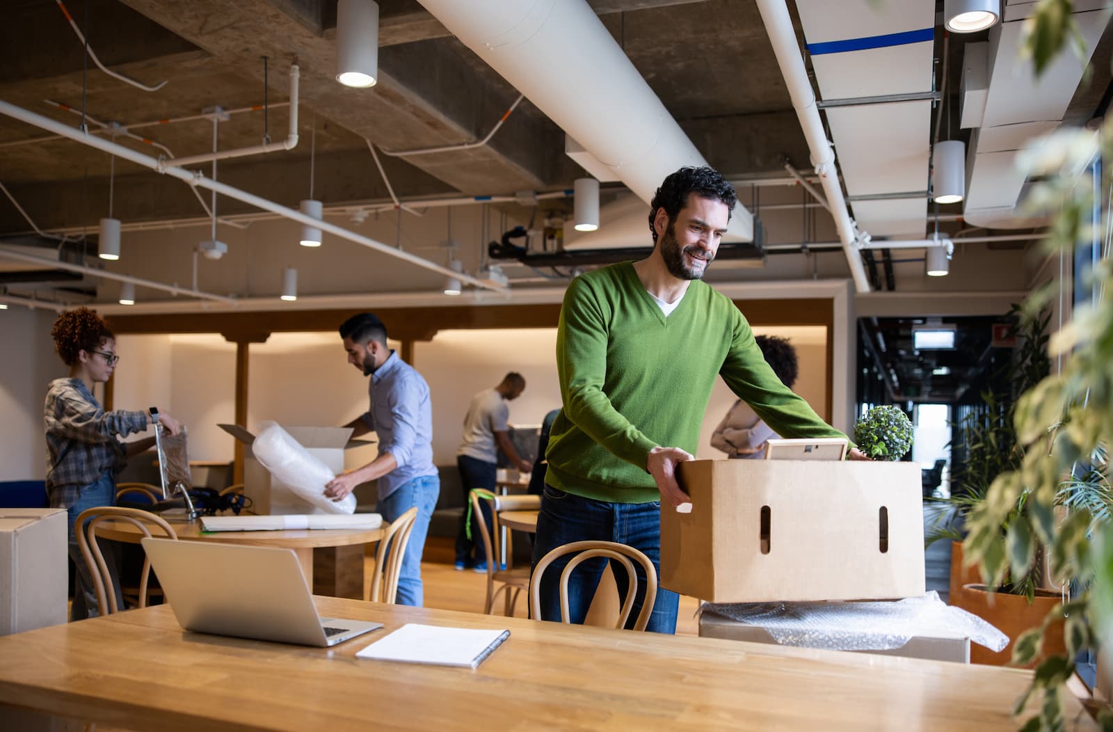 man moves office boxes around - Streamline Your Office Move: Top Strategies for Minimal Downtime with A Mother's Touch Movers in Melbourne